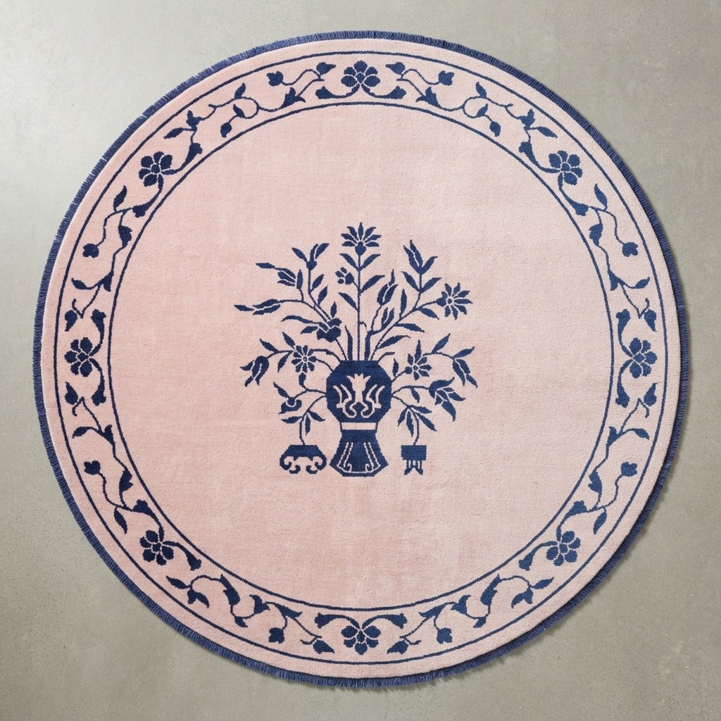 Blush Pink Round Hand-Knotted Rug with Navy Floral Vase - studio photo