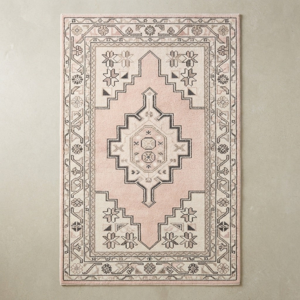 Blush Pink and Ivory Tribal Medallion Hand-Tufted Rug with Charcoal Accents - studio photo