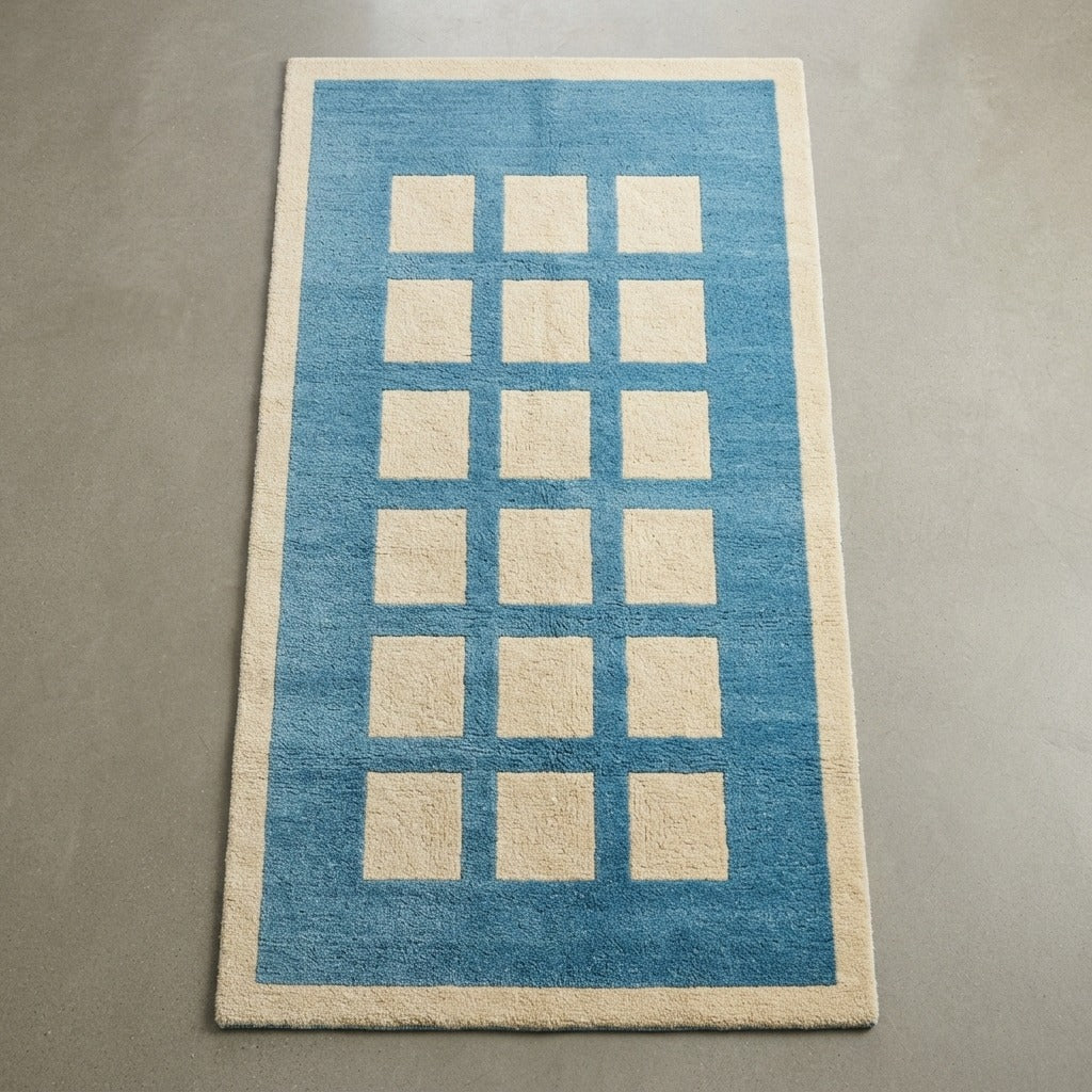 Cerulean Blue Hand-Tufted Rug with Cream Block Grid - studio photo