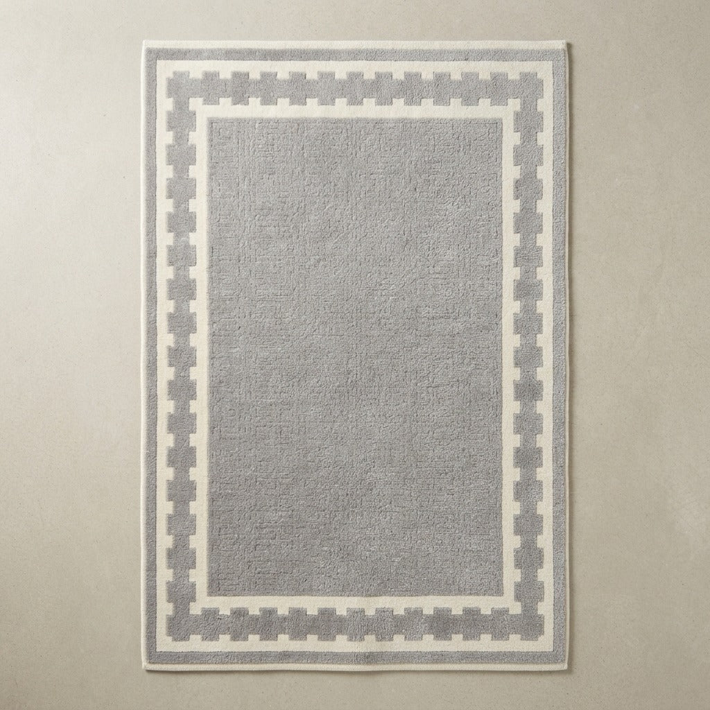 Dove Grey Hand-Tufted Rug with Ivory Crenellated Border - studio photo