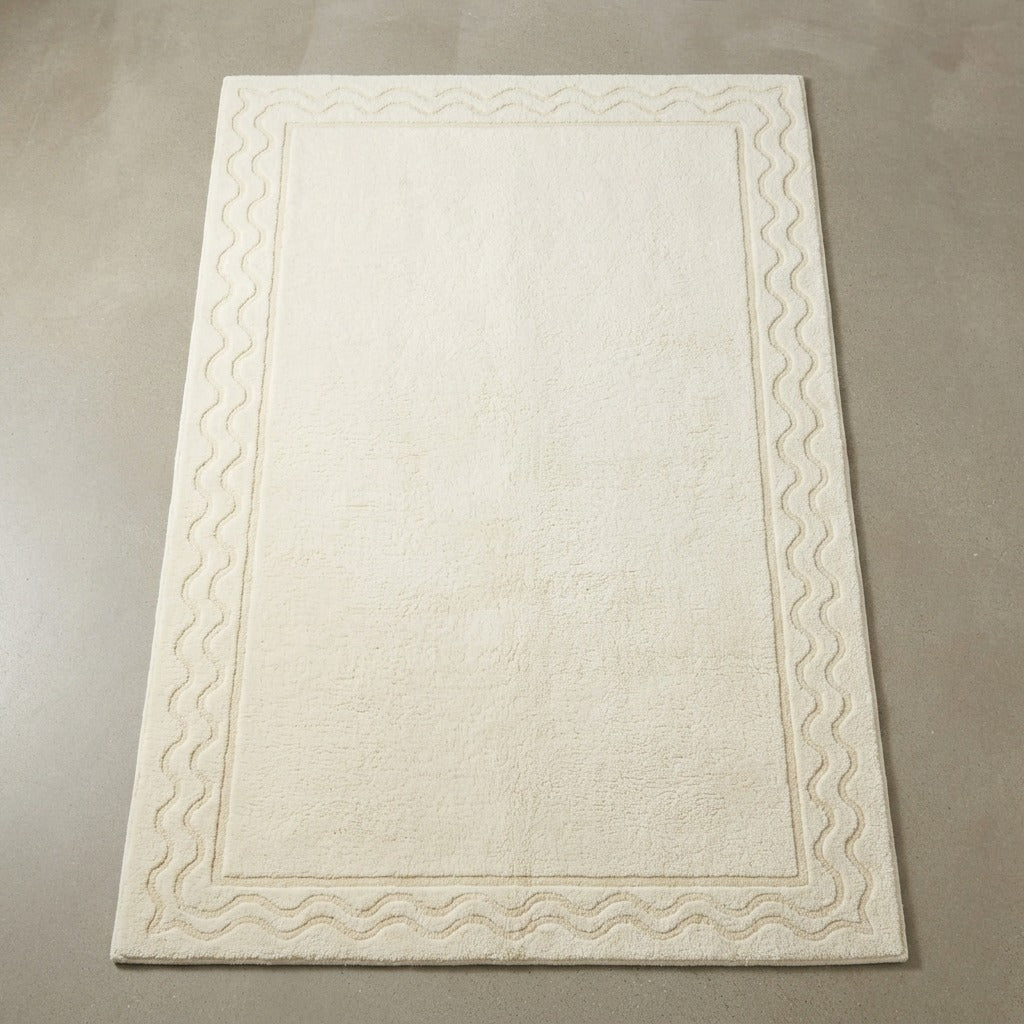 Ivory Tone on Tone Hand-Tufted Rug with Carved Wave Border - studio photo