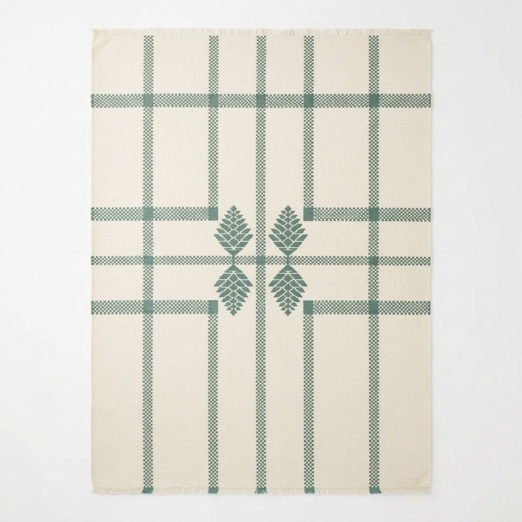 Ivory Windowpane Cotton Flat Weave Rug with Forest Green Pinecone Motif - studio photo