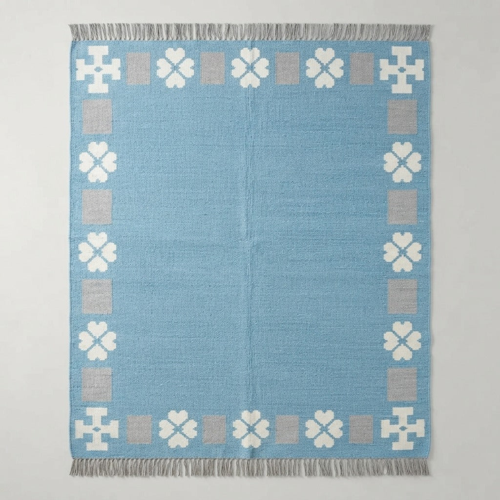 Powder Blue Cotton Flat Weave Rug with Ivory Clover Border - studio photo