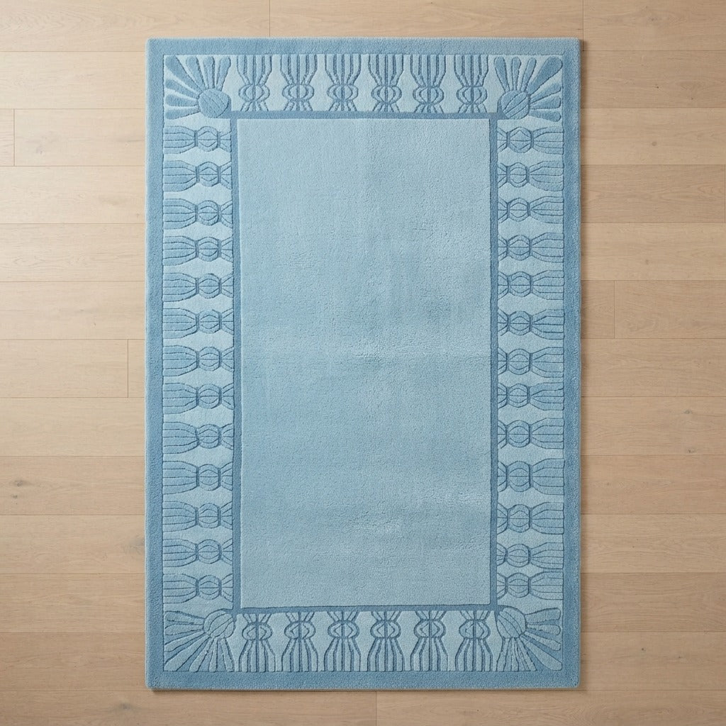 Powder Blue Hand-Tufted Rug with Carved Fan Tassel Border - studio photo