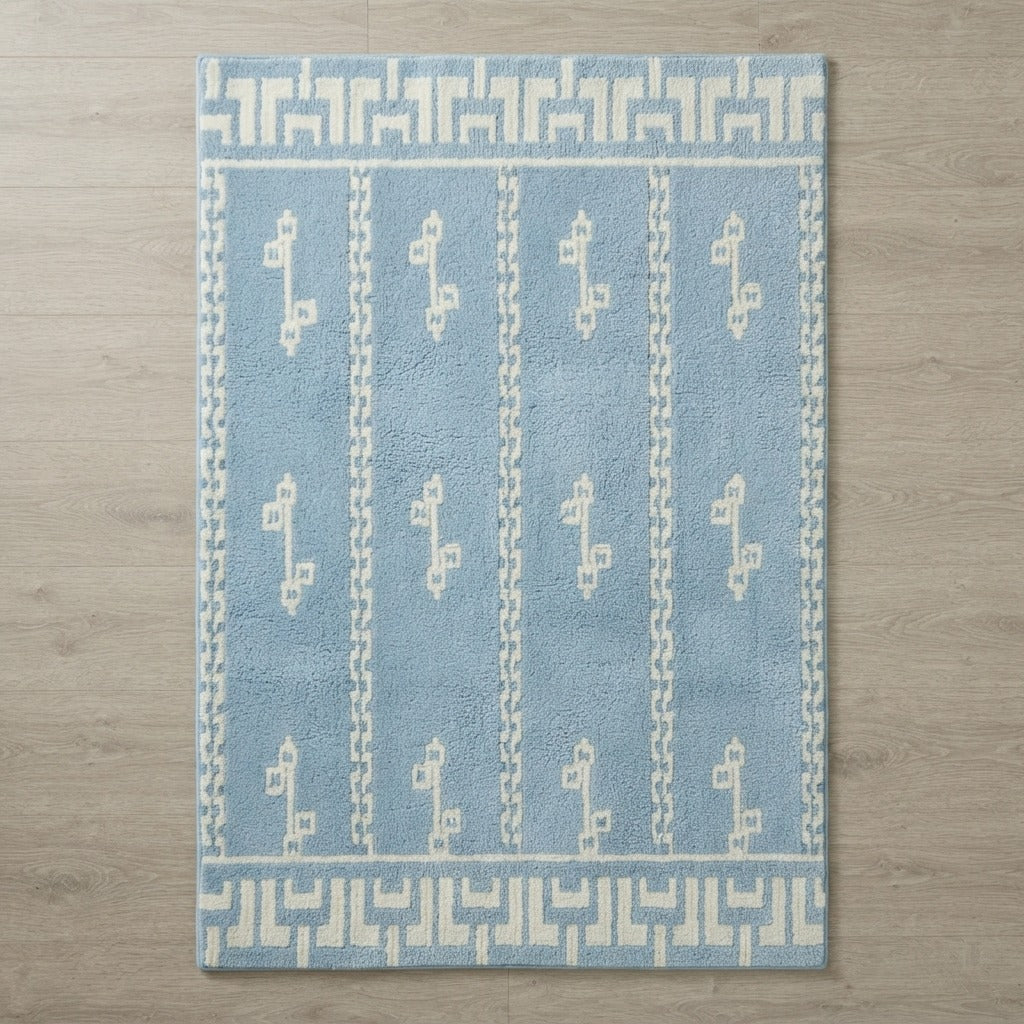 Powder Blue Striped Hand-Tufted Rug with Cream Glyph Motifs - studio photo