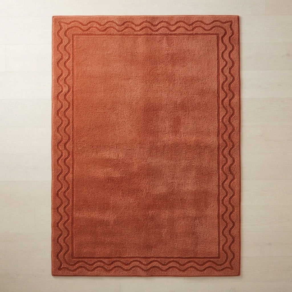 Rust Hand-Tufted Rug with Tonal Wave Border - studio photo