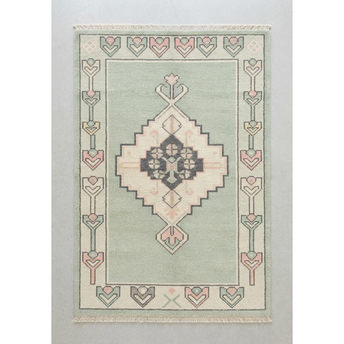 Sage Green Hand-Knotted Rug with Blush Medallion and Tulip Border - studio photo