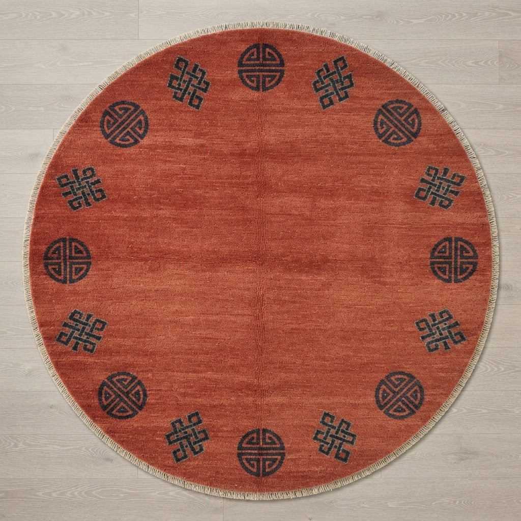 Terracotta Round Hand-Knotted Rug with Charcoal Shou Emblems - studio photo